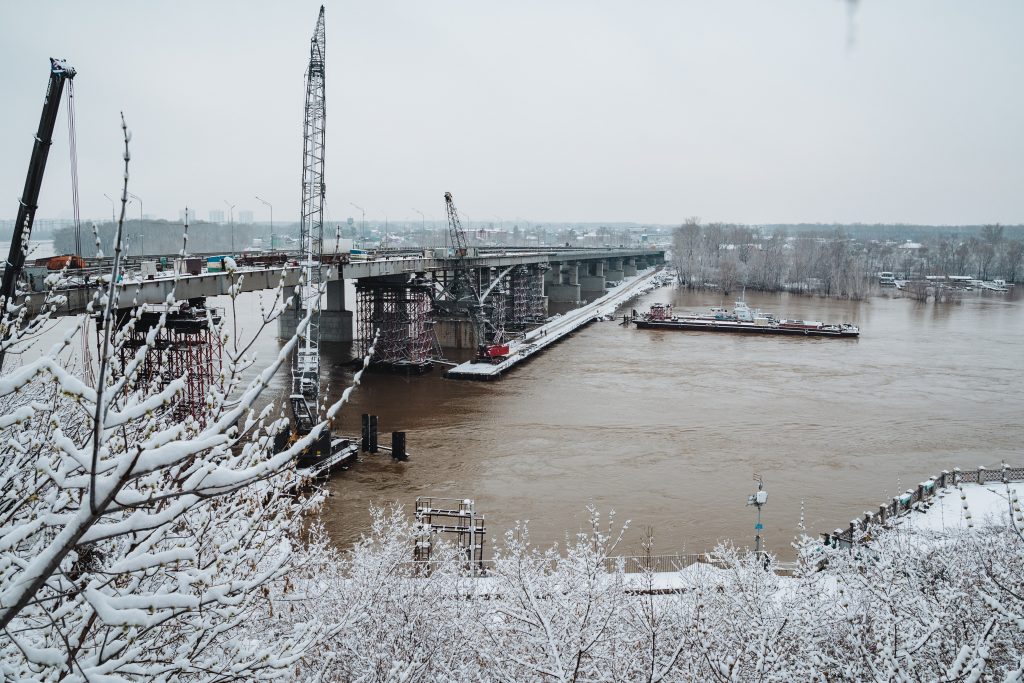 A major bridge is being built over a large body of water, enhancing transportation and connectivity for residents and visitors, making travel more efficient and accessible